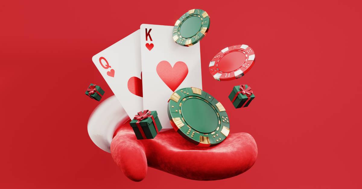 A red mitten with white fur lining holding miniature gift boxes, two playing cards, and gambling tokens.